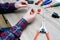 A male electrician changes the plug on an electric wire. Working with electrical tools. Stripper, crimp, screwdriver, wire cutters