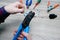 A male electrician changes the plug on an electric wire. Working with electrical tools. Stripper, crimp, screwdriver, wire cutters