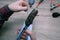 A male electrician changes the plug on an electric wire. Working with electrical tools. Stripper, crimp, screwdriver, wire cutters