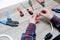 A male electrician changes the plug on an electric wire. Working with electrical tools. Stripper, crimp, screwdriver, wire cutters