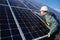 Male electrician checking photovoltaic solar panel.