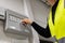 Male Electrician Opening Fire Panel In Server Room