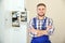 Male electrician standing near fuse board