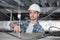 Male electrician on stepladder installing ceiling light