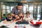 Male electronic engineer with european school children working in smart school lab and testing model of radio controlled