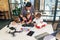 Male electronic engineer with european school children working in smart school lab and testing model of radio controlled