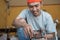 Male electronics worker installs new coils while repairing water pump machine