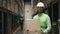 Male Employee with Box in a Well-Stocked Retail Warehouse. People Portrait