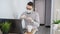 Male employee wear protective medical face mask, speak talk on video call with colleagues on online briefing, worker conference