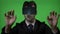 Male engineer dressed in suit and tie using virtual reality technology to type and check blockchain data on green screen -