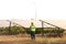 Male engineer holding notebook and work record to inspect solar system. Outdoor. Concept of electric power technology industry.