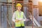 A male engineer looks at the floor plan at the construction site