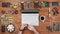 Male engineer programmer copies files from a flash card action camera on a laptop. Wooden table top view. Uses