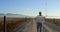 Male engineer walking with blueprint in the wind farm 4k