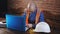 Male engineer working in the room for a laptop in overalls, hard hat lies beside him on the table.