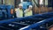 Male engineers at industrial factory. Two experts are observing a rolling conveyor