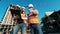 Male engineers are operating a laptop at the construction yard