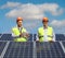 Male engineers on a roof with photovoltaic solar panels