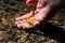 Male european hand refreshing in meditative zen atmosphere in a crystal clear water of a flat little creek with silky ripples