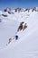 Male extreme skier skiing down a very steep couloir in deep winter in the Swiss Alps near Klosters