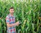 Male farmer checking plants on his farm. Agribusiness concept, agricultural engineer standing in a corn field with a tablet,