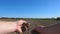 Male farmer hands holds a handful of dry ground and checks soil fertility on the field. Arms of young man pouring land