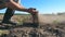 Male farmer hands holds a handful of soil and pouring it back through his fingers on the field. Young man examining dry