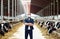 Male farmer in mask with cows on dairy farm