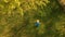 Male farmer mows the grass at sunset