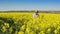 Male Farmer in Oilseed Rapeseed Cultivated Agricultural Field Examining and Controlling The Growth of Plants