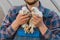 A male farmer rural man in a shirt and overalls holds a two white brama chicken in his hands, close up