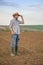 Male Farmer Standing on Fertile Agricultural Farm Land Soil