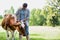 Male farmers checking on their cows on their farm