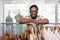 Male fashion designer leaning on rack of clothes