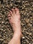 Male feet covered with sand on the beach