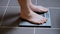Male feet on glass scales, men`s diet, body weight