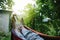 Male feet in hammock close-up, unrecognizable person, summer rest and vacation