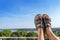 Male feet in leather slippers relaxing on balcony