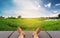 Male feet relaxing on leather bed at rice field in countryside area in sunrise morning