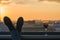 Male feet in shoes on the balcony. city and sunset background