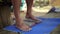 Male feet stand on a wooden yoga board with lot of metal nails pins then step out from it carefully