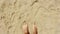 Male feet walk along the sandy beach. A man enjoys relaxing on the sandy beach. A man walks on the sand by the sea.