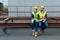 male and female architects in hardhats with blueprint on coffee break sitting