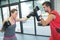 Male and female boxing at gym at boxing ring