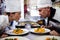 Male and female chefs looking at each other in kitchen