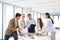 Male and female design professionals having discussion at table in new office