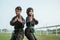 Male and female fighters wearing pencak silat uniforms perform side stances