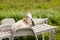 Male and female goats lounging on lounge chairs in summer