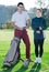 Male and female golfers ready for team play at golf course