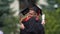 Male and female graduates in academic caps hugging, friends sorry to say goodbye